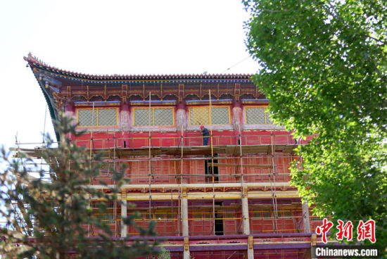 圖為5月上旬，甘肅山丹縣大佛寺內(nèi)，工作人員對古建筑大雄寶殿進(jìn)行修繕。 中新社記者 高展 攝